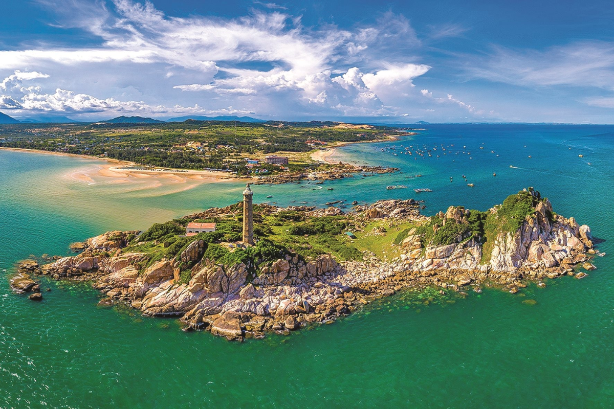 Aerial view of Ke Ga Lighthouse surrounded by turquoise sea